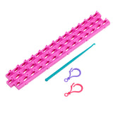 A Cra-Z-Loom Ultimate Rubber Band Loom, a green crochet hook, and two rubber bands, one purple and one red, are placed on a white background.
