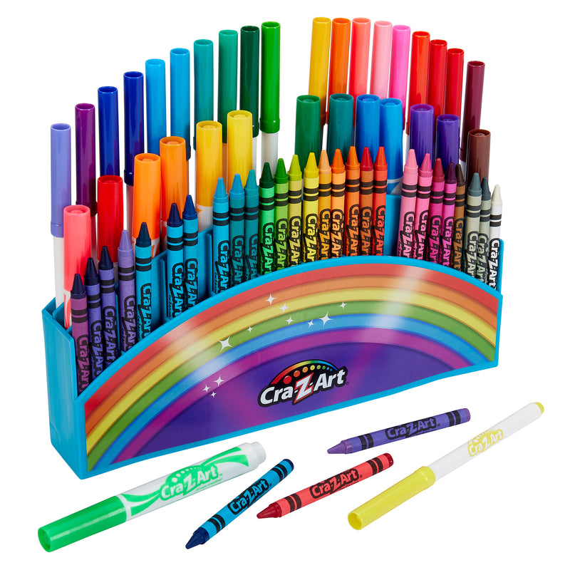 A colorful Cra-Z-Art Amazing Art Case 83 pieces organized in a standing case with a rainbow design. Several crayons and markers are scattered in front.