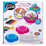 Packaging for "Shimmer 'n Sparkle Glitter Globes: Create Colorful 3D Keepsake Art with Glitter Magic!" kit, showing images of finished globes, colorful molds, and included materials: 2 domes, stands, clay sticks, glitter, and tools with instructions.