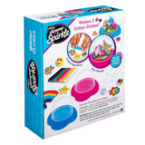 A craft kit box labeled "Shimmer 'n Sparkle Glitter Globes: Create Colorful 3D Keepsake Art with Glitter Magic!" that includes supplies to create two glitter globes. The box shows examples of completed globes, tools, and materials included.