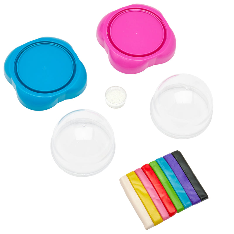 Two plastic molds (one blue, one pink), two clear plastic covers, a small container of white powder, and nine sticks of colored clay arranged in a row from the Shimmer 'n Sparkle Glitter Globes: Create Colorful 3D Keepsake Art with Glitter Magic!