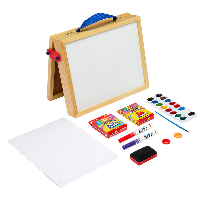 A Cra-Z-Art 16 x 12 inch Wooden Tabletop Easel: 5-in-1 Creativity Station with Complete Art Supplies!, accompanied by paper, crayons, markers, a paint set, and an eraser.
