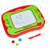 A Travel Magna Doodle with a stylus on the right and geometrical magnet stamps below. The board shows simple drawings including stars and a wavy line.