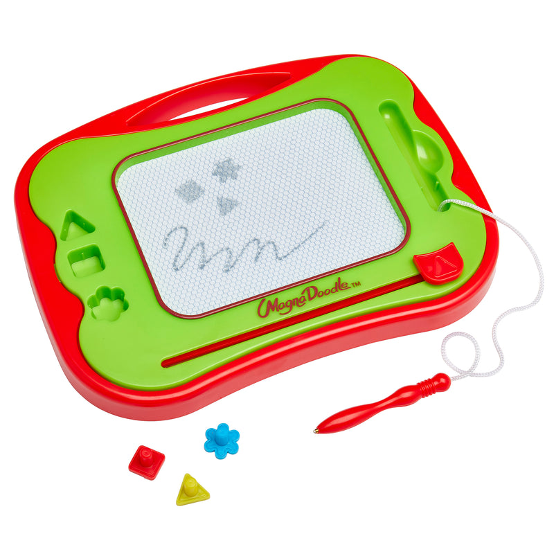 A Travel Magna Doodle with a stylus on the right and geometrical magnet stamps below. The board shows simple drawings including stars and a wavy line.