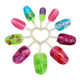 A circular display shows ten colorful, decorated nail designs attached to a heart-shaped holder. Designs include stars, hearts, peace signs, glitter, and various patterns from the Shimmer 'n Sparkle 8 In 1 Lite-up Designer Nail Studio.