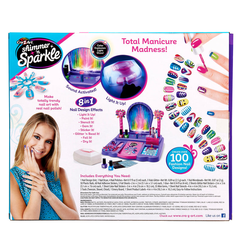 The image shows the back of a "Shimmer 'n Sparkle 8 In 1 Lite-up Designer Nail Studio" package, advertising various nail design features, accessories, and over 100 fashion nail designs.