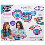 Two girls crafting bead bracelets using the Shimmer 'n Sparkle 2 in 1 Spin & Bead Bracelet Studio. The background shows various included tools, like beads, thread, and accessories for over 25 bracelets.