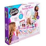 Packaging of the "Shimmer 'n Sparkle Light Up Beauty Studio" showcasing the toy makeup set with mirror, nail polish, and other beauty accessories.