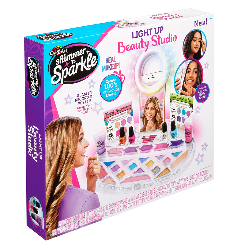 Packaging of the "Shimmer 'n Sparkle Light Up Beauty Studio" showcasing the toy makeup set with mirror, nail polish, and other beauty accessories.