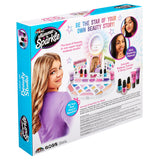 Back of the "Shimmer 'n Sparkle Light Up Beauty Studio" makeup kit packaging, featuring product contents, images of young girls, and promotional text highlighting makeup tutorial and story contents.