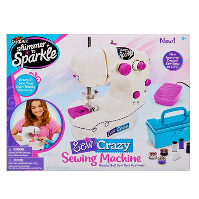 Box containing the Shimmer 'N Sparkle Sew Crazy Sewing Machine: Safe Starter Tool for Young Fashionistas!, showing images of the machine, accessories, and a person using it. Text indicates it is suitable for ages 8 and up.