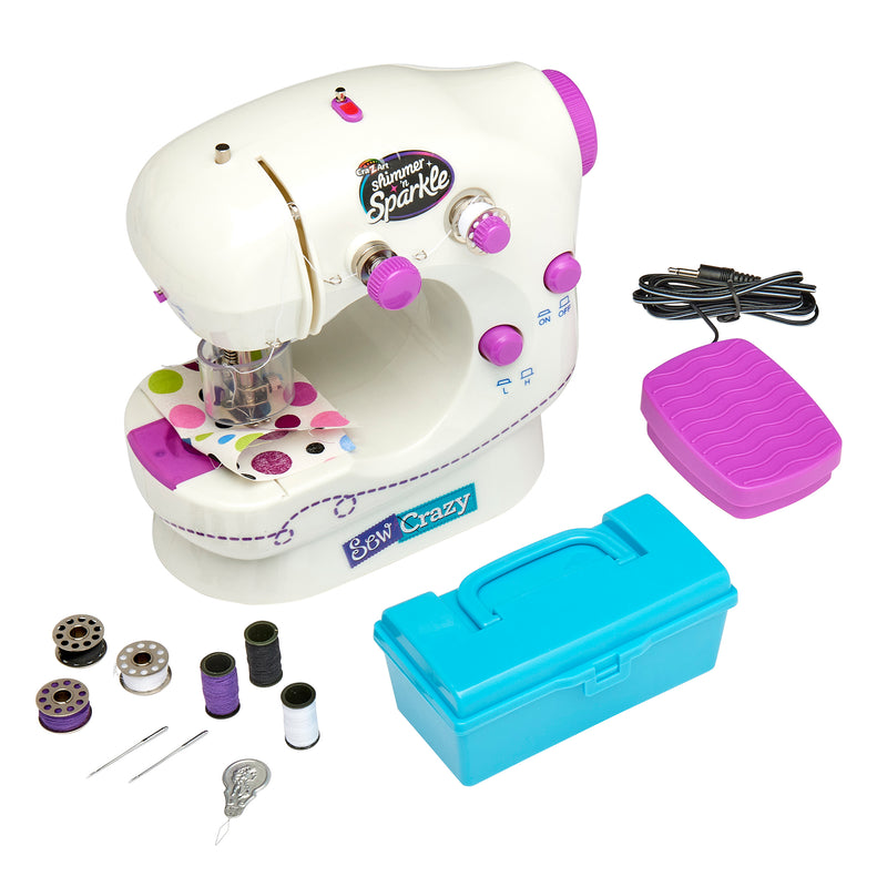 Shimmer 'N Sparkle Sew Crazy Sewing Machine: Safe Starter Tool for Young Fashionistas! with assorted accessories including bobbins, spools of thread, needles, a foot pedal, and a blue storage box. The machine and accessories are in shades of white, purple, and pink.