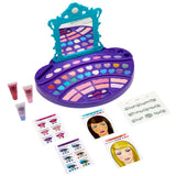 A Cra-Z-Art Shimmer 'n Sparkle Real Ultimate Make Up Designer featuring a mirror, various cosmetic powders in a purple and blue palette, two tubes of gloss, design sheets for face painting, and illustrated guides.