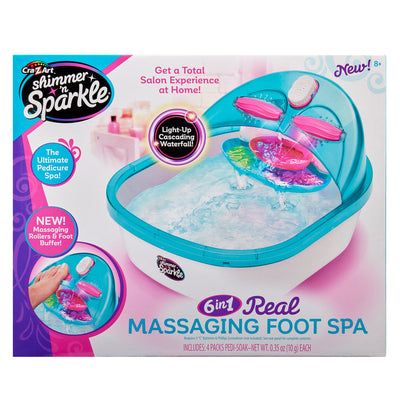 Packaging of the Shimmer 'n Sparkle 6 in 1 Massaging Foot Spa. It features a light-up cascading waterfall, massaging rollers, foot buffer, and includes 4 packs of pedi-soak. Suitable for ages 8+.
