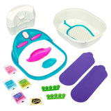 Shimmer 'n Sparkle 6 in 1 Massaging Foot Spa with a white and blue basin, blue and pink attachments, green toe separators, purple foot pads, and various small packets of foot care products.