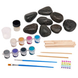 The Cra-Z-Art Shimmer 'n Sparkle Metallic Mania Rock Art includes black stones, paint pots in various colors, a paintbrush, wooden sticks, adhesive gems, and a small container.