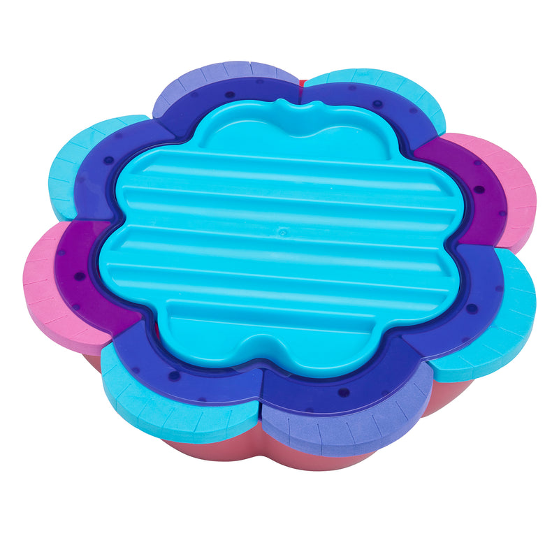 A colorful, flower-shaped plastic container with a blue, ridged lid and multiple layers in purple, violet, pink, and blue is called the Shimmer 'n Sparkle 6 in 1 Friendship Bracelet Studio.