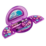 A purple, glittery Shimmer 'n Sparkle All In One Real Beauty Compact with various colors and shapes, featuring an illustration of a unicorn on the inner lid. It includes an eyeliner pencil and makeup brushes.