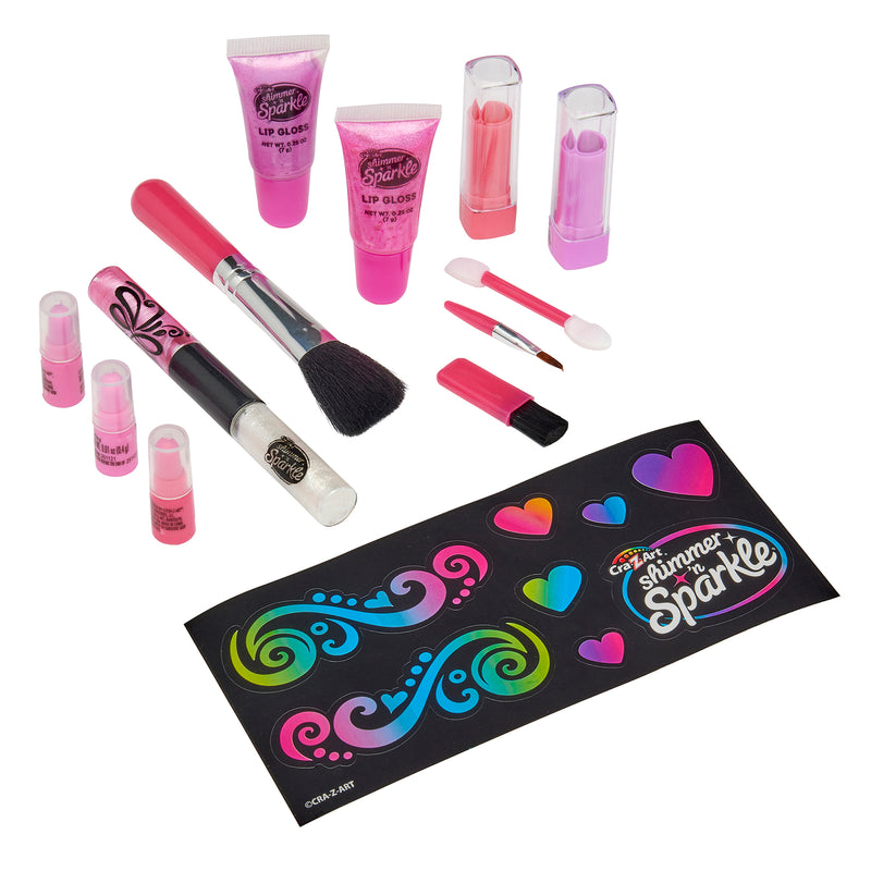 A collection of children's makeup items including lip gloss, lipsticks, brushes, and applicators arranged with a sticker sheet that says "Shimmer 'n Sparkle Glitter Case.