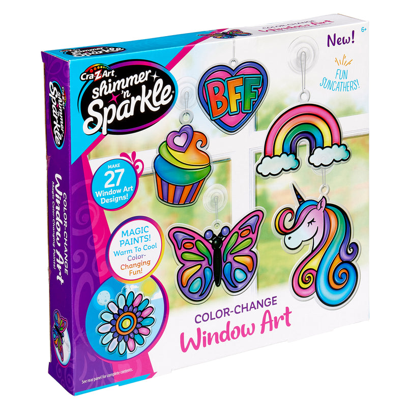 Shimmer 'n Sparkle Color Change Window Art kit includes 27 designs like a unicorn, cupcake, and butterfly. The packaging highlights color-changing fun with paint pens. For ages 6 and up.