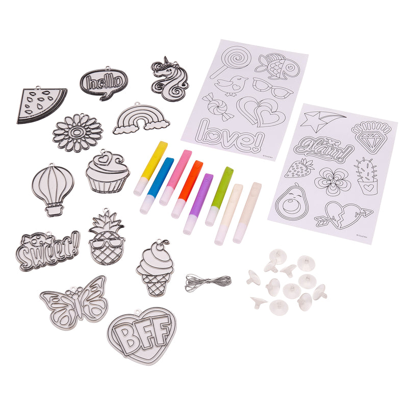 A Shimmer 'n Sparkle Color Change Window Art includes various shaped line drawings (flowers, food, unicorn) with markers, and attachment accessories for creating charms or badges.