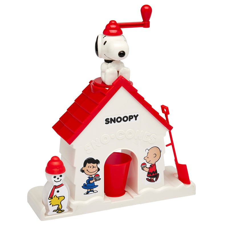 A Snoopy Snow Cone Maker featuring a red roof and decorated with cartoon characters. Snoopy sits atop the roof with a red handle, and a red cup and shovel are at the base.