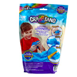 A package of Cra-Z Sand Blue Blast 3lb Bag featuring a child playing with blue sand. The package highlights "includes surprise hidden tool," "shape it," "mold it," and shows a hidden tool being uncovered.