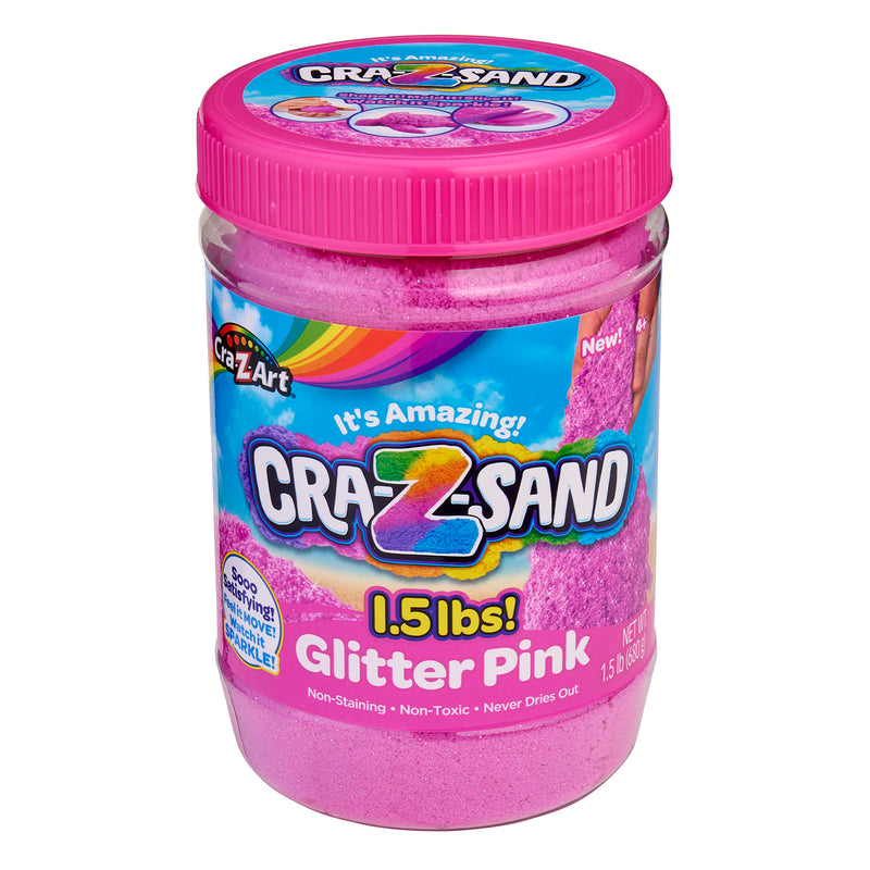 A jar of Cra-Z-Sand Pink Glitter Sand, 1.5 LB Tub. The packaging highlights the product as non-staining, non-toxic, and never dries out.