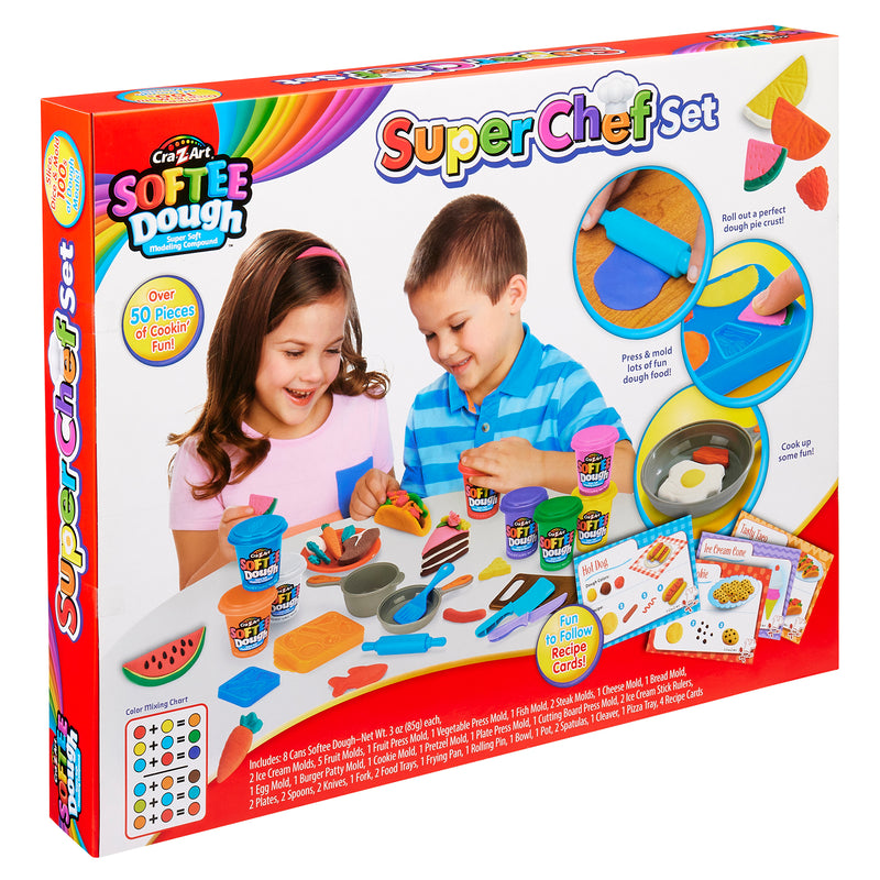 Two children playing with Softee Dough Super Chef Set, which includes play dough, kitchen utensils, and molds for creating food shapes. The box highlights over 50 pieces and recipe cards.