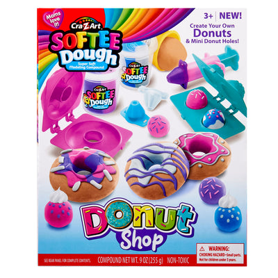A colorful playset box showing "Softee Dough Donut Shop Medium box". Includes modeling compounds and tools to create toy donuts and donut holes, for ages 3 and up. Warning of small parts included.