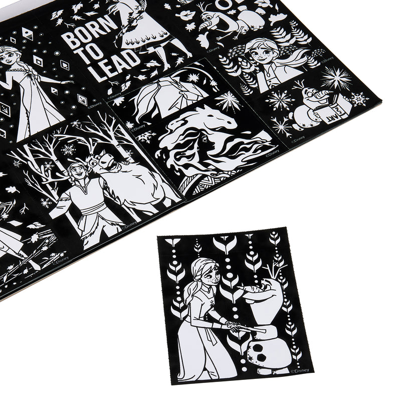 A Disney Frozen 2 Fuzzy Poster Jumbo Pad and a separate sheet feature black and white outlines of characters in various scenes. One character is building a snowman on the separate sheet. Text reads "Born to Lead.