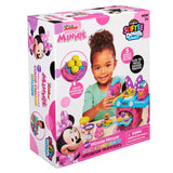 Box for "Disney Minnie Softee Dough Color Change Kitchen" featuring a young girl playing with colorful dough and kitchen accessories. The set includes 5 bright dough colors and is for ages 3 and up.