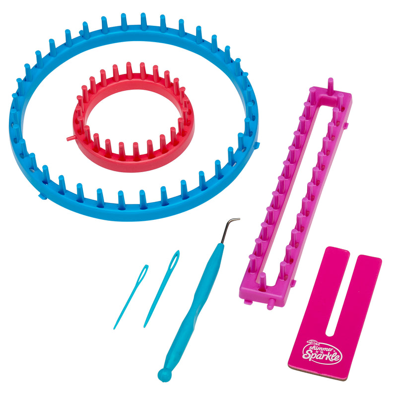 The Shimmer 'n Sparkle 3 in 1 Ultimate Knitting Station containing two round looms, one rectangular loom, two plastic needles, a hook tool, and a pink separator card.