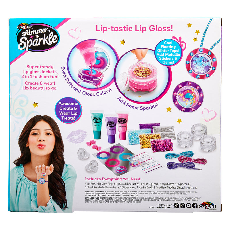 A Shimmer 'n Sparkle Glitter & Gem Lip Gloss Lockets set featuring tubes of gloss, glitter, metallic stickers, gems, and jars. The packaging showcases a child blowing a kiss, colorful lip gloss options, and contents of the product.