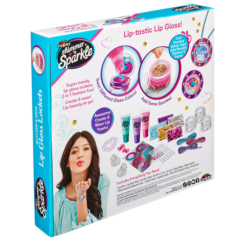 Back of a "Shimmer 'n Sparkle Glitter & Gem Lip Gloss Lockets" kit box showing product details. Text describes contents and features with images of included items like lip gloss containers, tools, and decorative accents.