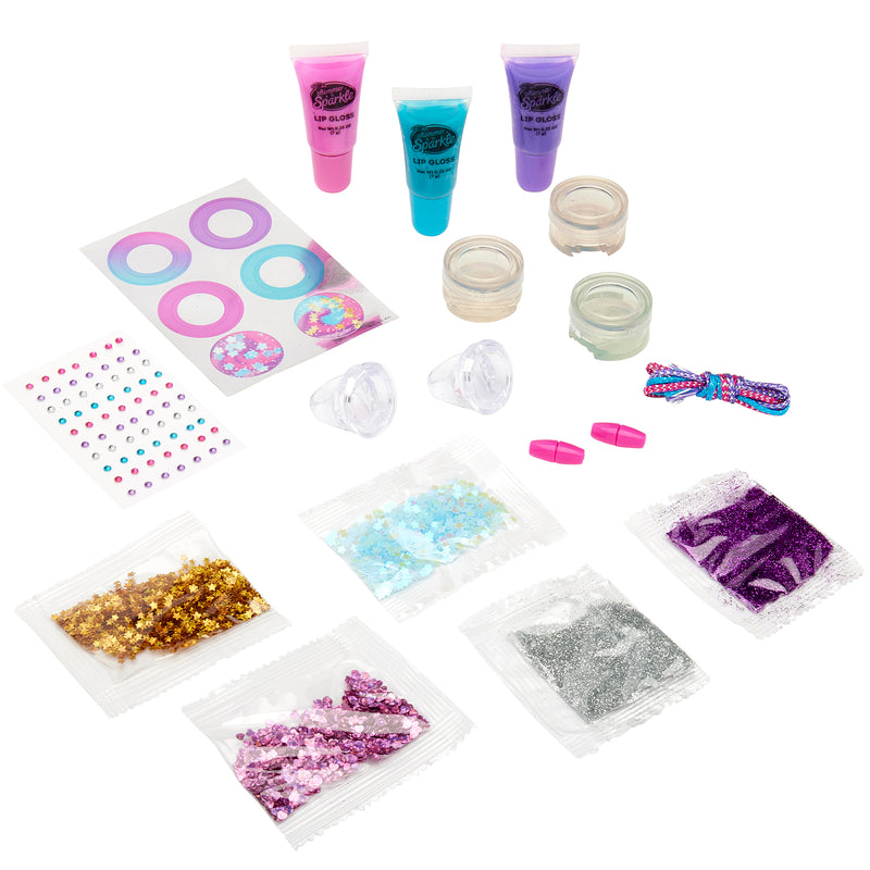 A collection of Shimmer 'n Sparkle Glitter & Gem Lip Gloss Lockets including tubes of lip gloss, jars, glitter packets, mixing bowls, a bow, applicators, and decorative stickers arranged on a white background.