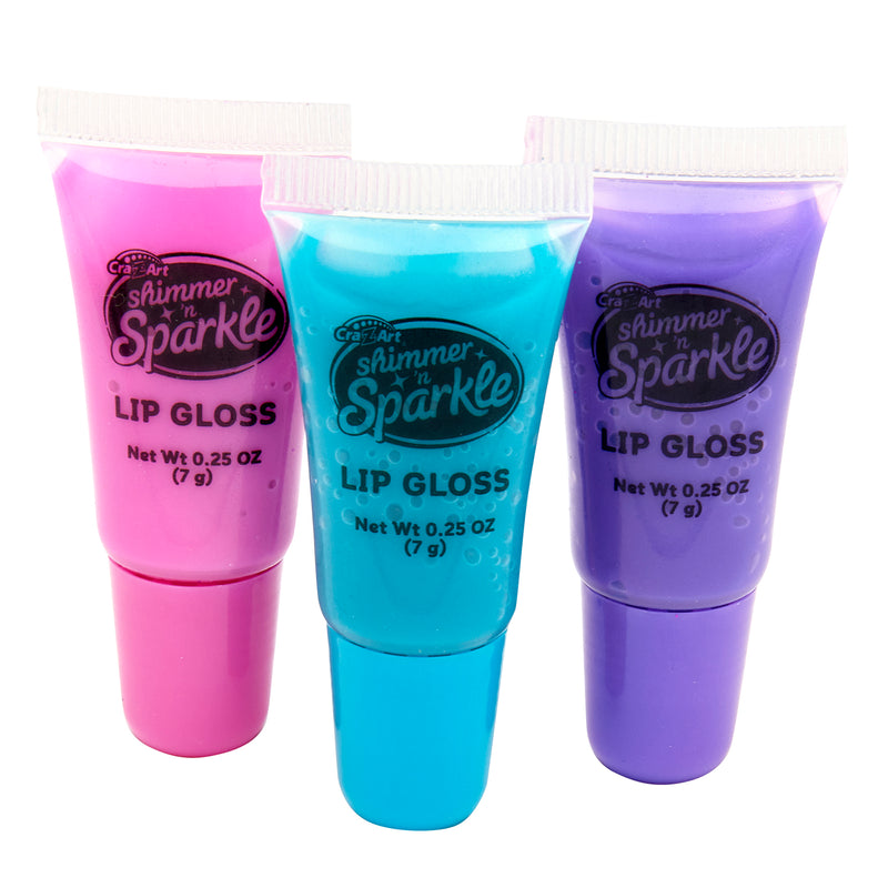 Three tubes of Shimmer 'n Sparkle Glitter & Gem Lip Gloss Lockets in pink, blue, and purple, each containing 0.25 oz (7 g) of product.