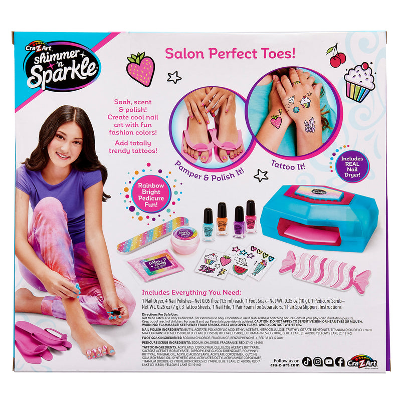 Image of a toy set called "Shimmer 'n Sparkle Ultimate Pedicure Party" featuring a girl painting her toenails. The set includes nail polish, stickers, a nail dryer, and other accessories for pedicures.