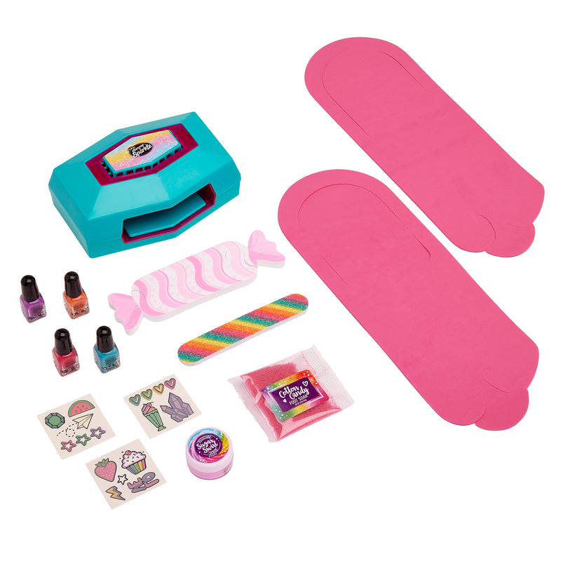 A set of Shimmer 'n Sparkle Ultimate Pedicure Party, including a teal carrying case, stickers, nail polish bottles, a nail file, glitter, and two long pink pieces of paper.