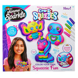 Product packaging for "Shimmer 'n Sparkle Cra-Z-Squeezies Color Your Own Squeezie Fun" showing colorful, squeezable toys and markers. The box features a girl holding the toys and highlights they are scented, soft to squeeze, and for ages 6 and up.