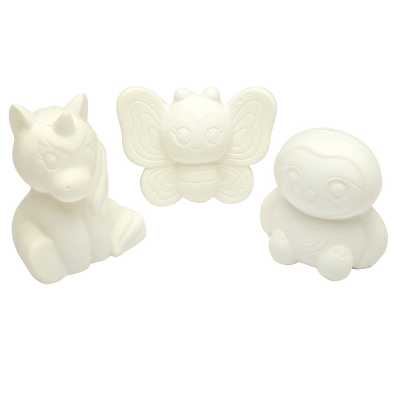 Three unpainted, white Shimmer 'n Sparkle Cra-Z-Squeezies Color Your Own Squeezie Fun figurines featuring a unicorn, a butterfly, and an owl, each with a cute cartoonish design and detailed features.