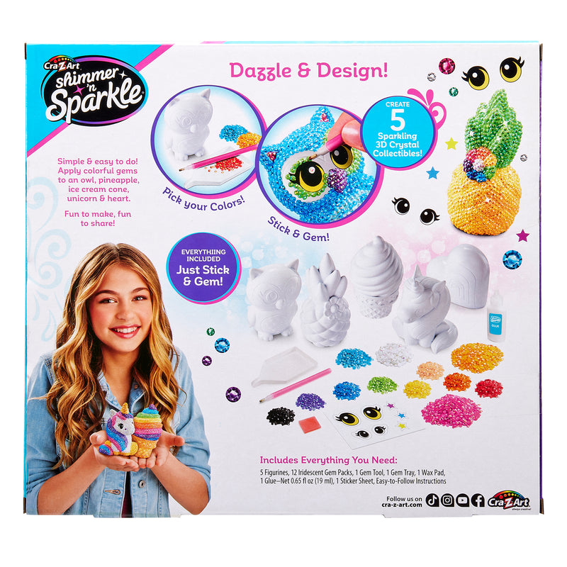 Box of "Shimmer 'n Sparkle 3 D Crystal Gem Creations" craft kit featuring a young girl holding decorated figures, instructions for styling included, showing various materials and five possible collectible designs: unicorn, pineapple, owl, fish, and llama.