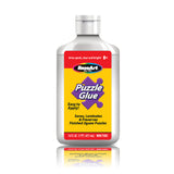 A bottle of RoseArt - 16 oz Puzzle Glue with a yellow label. The bottle is 16 fluid ounces (473 milliliters) and is designed to save, laminate, and preserve finished jigsaw puzzles.