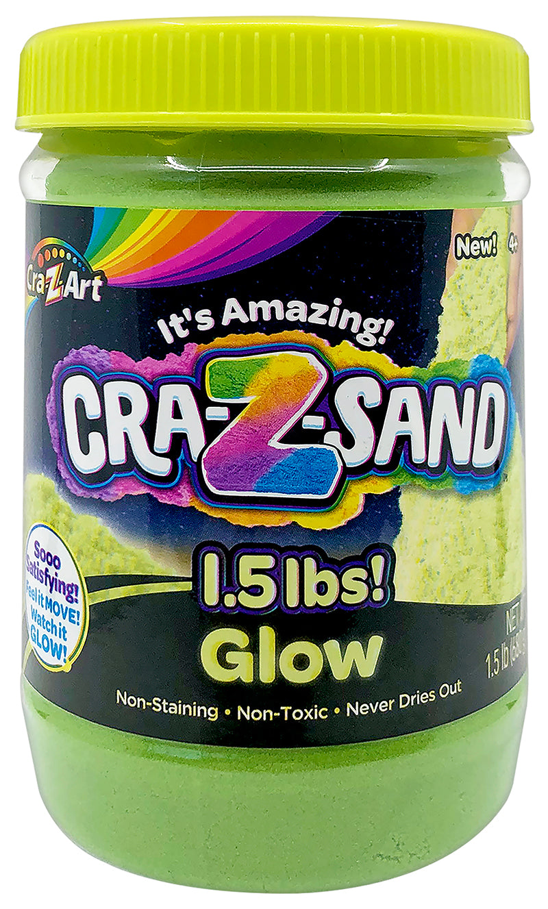 A jar of Cra-Z Sand Glow, labeled as 1.5 pounds. The packaging highlights the sand as non-staining, non-toxic, and never drying out.