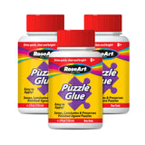 Three bottles of RoseArt - 4.5 oz Puzzle Glue 3 pack, each with a red lid and labeled as easy to apply, non-toxic, and suitable for ages 8 and up. The bottles contain 4.5 fl oz (133 ml) of glue.