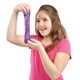 A girl in a pink shirt holds and stretches a piece of Cra-Z-Slimy Purple Smoothie, smiling.