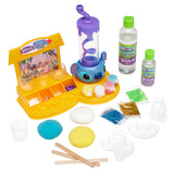 Create endless fun with the Stitch Slime Studio! This kit comes with bottles, powders, beads, glitter, containers, molds, mixing sticks, and a blue and purple mixer on a yellow base.